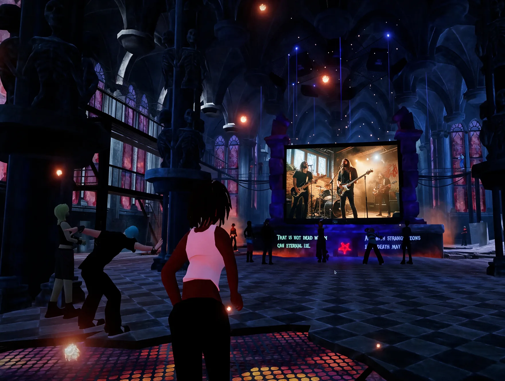 Speakers on stage with a virtual audience shown on a large screen behind them