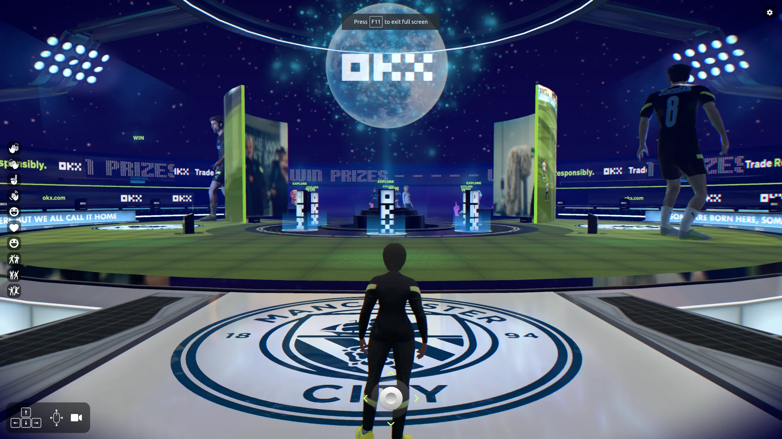 A first-person view standing on Manchester City's crest, facing a showcase stage inside a virtual fan zone